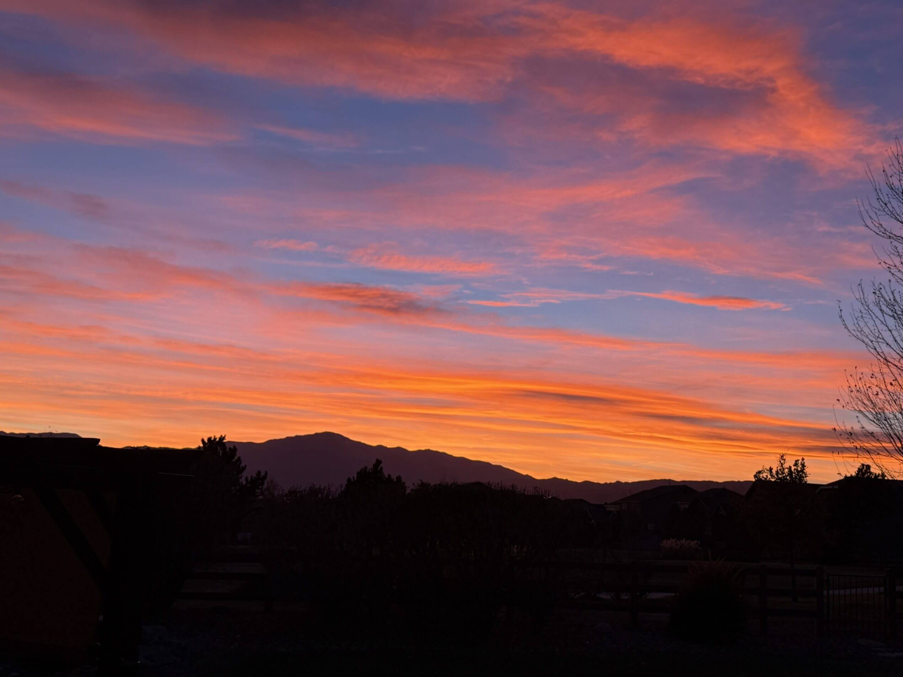 Colorful sunset sky over distant mountains.